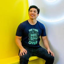 Load image into Gallery viewer, Warren staff wearing the navy The Time For Small Ideas Is Over shirt.  (4042752065645) (7433024602301)