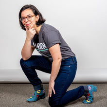 Load image into Gallery viewer, Warren Minimalist Unisex Asphalt T-shirt with White and Liberty green text. On model kneeling on the ground with hand on chin in thinking posture. (1519734849645) (7433026207933)