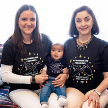 Load image into Gallery viewer, Two women holding a baby while seated on a couch. Three generations wearing the Pinky Promise T-shirt and Onesie in black.  (4170165682285) (7432140259517)