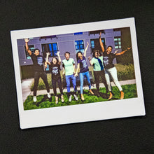 Load image into Gallery viewer, A Polaroid photo of Warren staff jumping outside.  (4043137220717) (7433024667837)