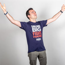 Load image into Gallery viewer, Dream Big, Fight Hard Unisex Navy T-shirt with White and Red Text. On model with arms spread wide to display the vastness of the big structural change we want. (1518922596461) (7432137736381)
