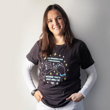 Load image into Gallery viewer, Woman wearing the Pinky Promise Unisex T-Shirt with her hand in her pockets layered over white long sleeve tee. (4170169516141) (7432140357821)